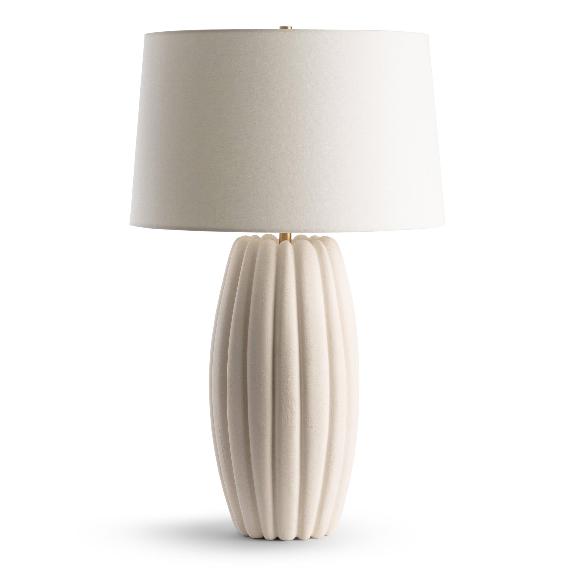 Beige table lamp with ribbed base and white shade on a white background